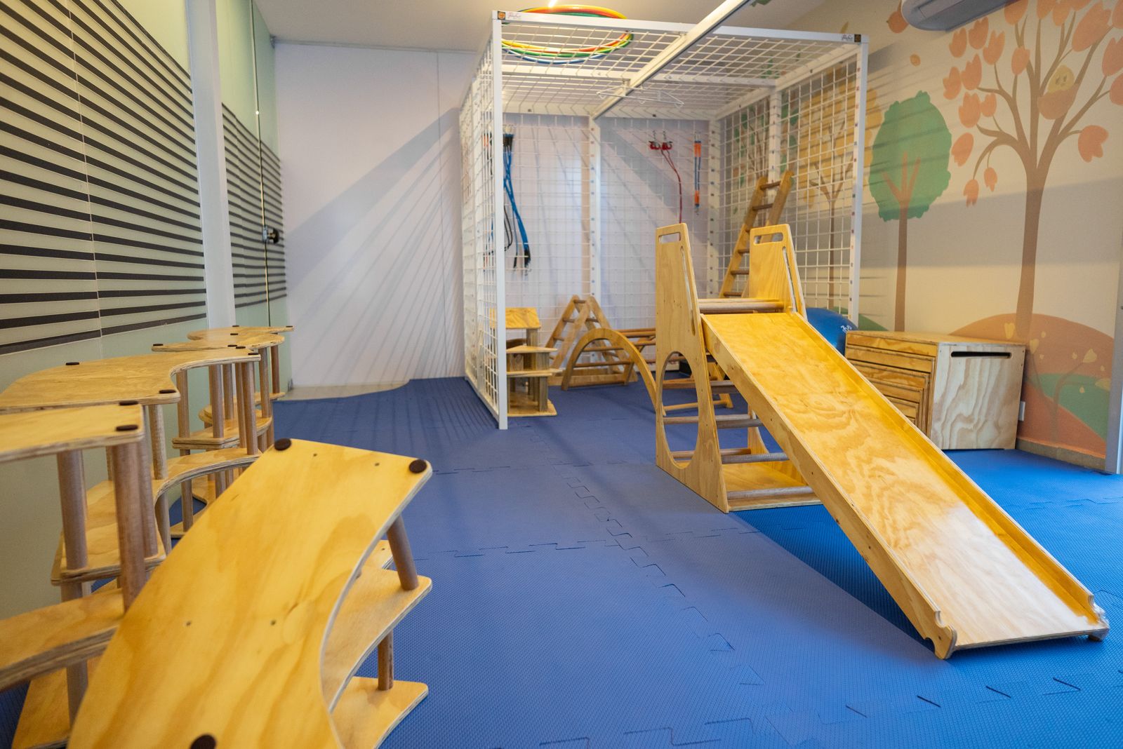 Sala de fisioterapia motora com rampas e equipamentos
